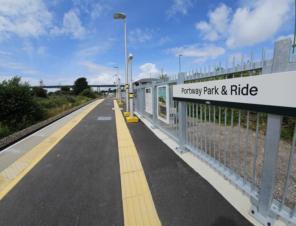 a first person view of the train platform and the Portway Park and Ride station sign