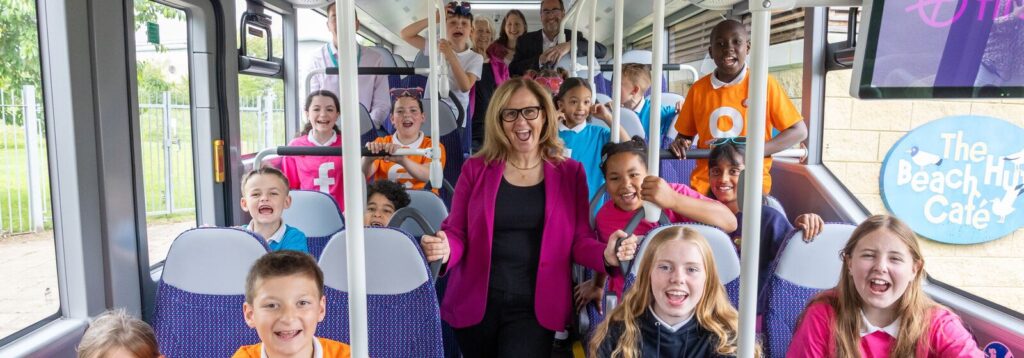 Mayor of the West of England and kids all sat on a bus smiling and happy as part of the Kids go Free campaign