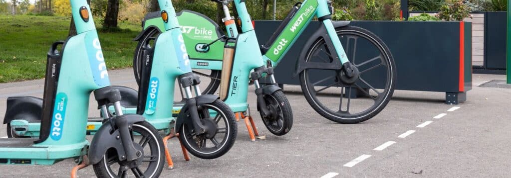 Close up image of Electric scooters and bike in a row