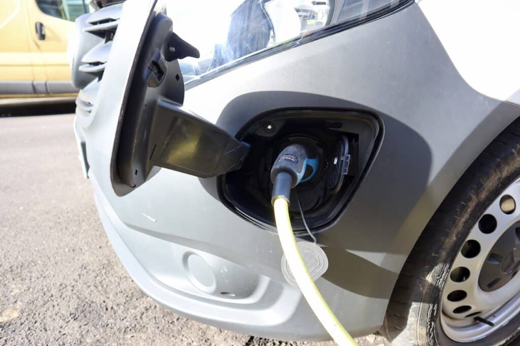 EV charger plugged into a car on a residential street