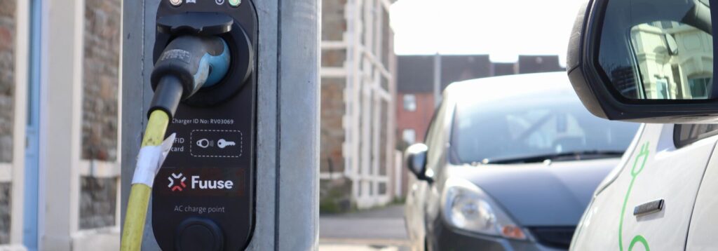 A close up view of the public EV charger on a lamppost on a residential street.