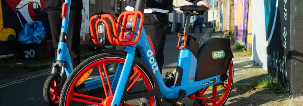 Close up image of a blue and red Dott branded E-bike and E-scooter