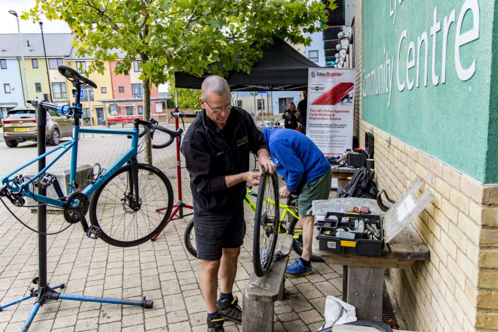 Photo of Dr Bike mechanics fixing bicycles raised on repair stands.