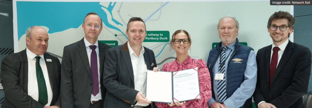 National Rail, North Somerset Leader and the West of England Mayor holding the signed contract for works to continue on the Portishead line.