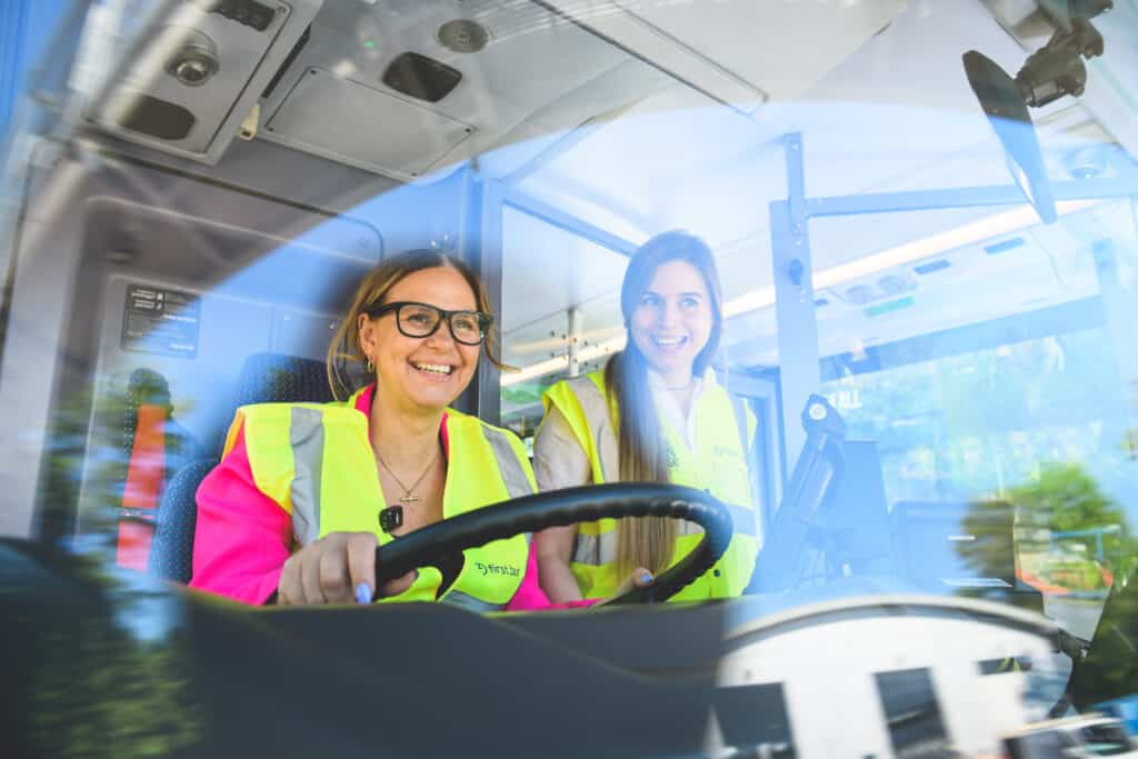 West of England Mayor sat in the drivers cabin of a bus smiling