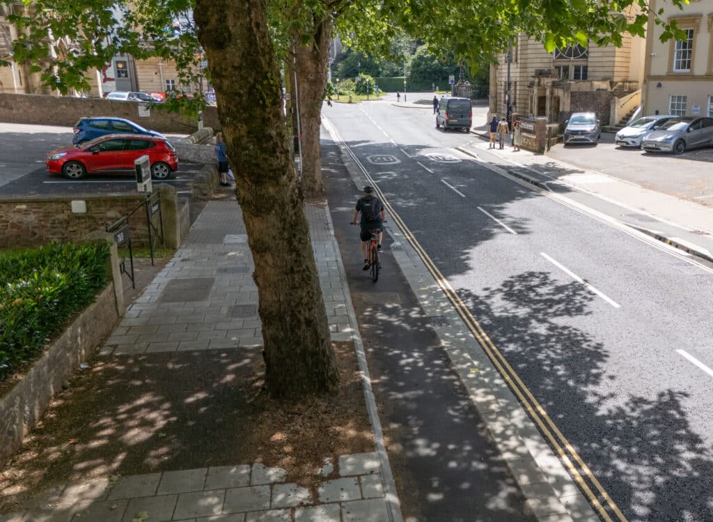Arial view of the new Whiteladies Road flooding defence and raised cycle lane with tree trunks and buildings either side.