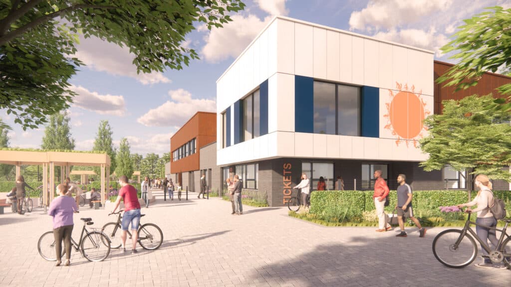 Visualisation of Bristol Regional Cycling Hub main elevations showing a large patio front area with trees and seating and a white building with a picture of a sun on the side of it.